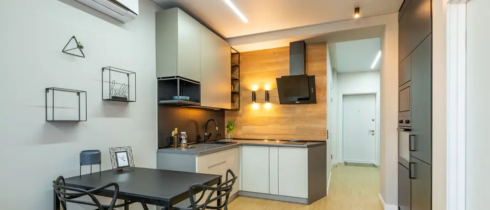 A bright open living space with a ductless air conditioner high on the wall