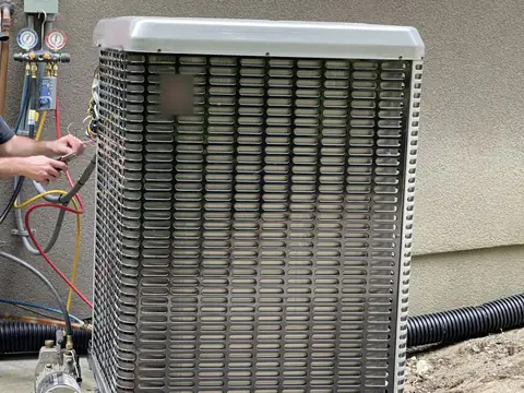 Gauge hoses connected to a new outdoor AC unit