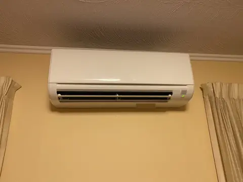 The indoor unit of a ductless system on a bedroom wall