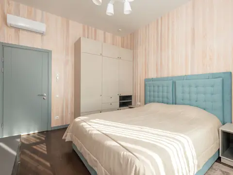 A ductless indoor head mounted high on a bedroom wall
